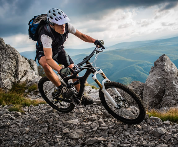 Mountain biker riding down a trail after enjoying Zipfizz the healthy on the go energy supplement of the outdoors