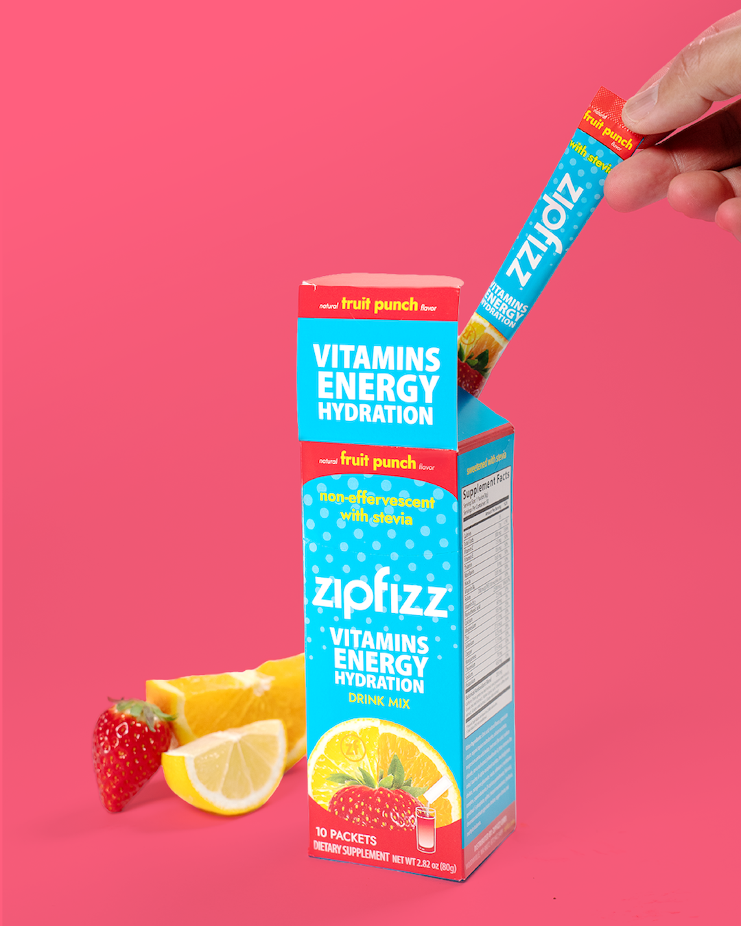 Zipfizz vitamin energy hydration package with a strawberry, lemon, and orange on a pink background
