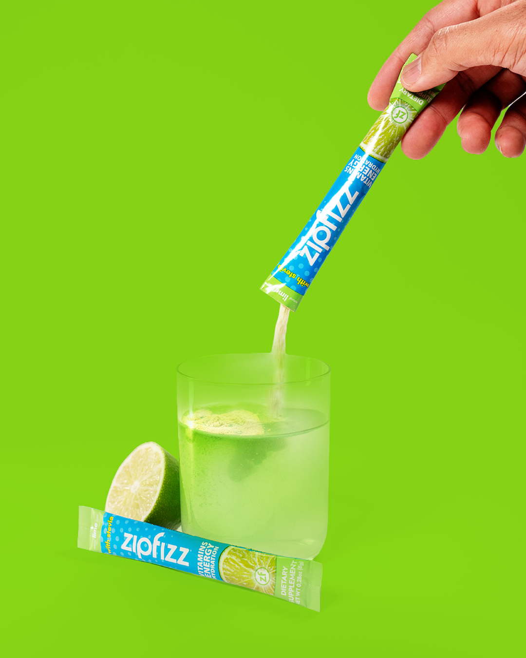 Ziofizz lime flavor drink mix being added to a glass.